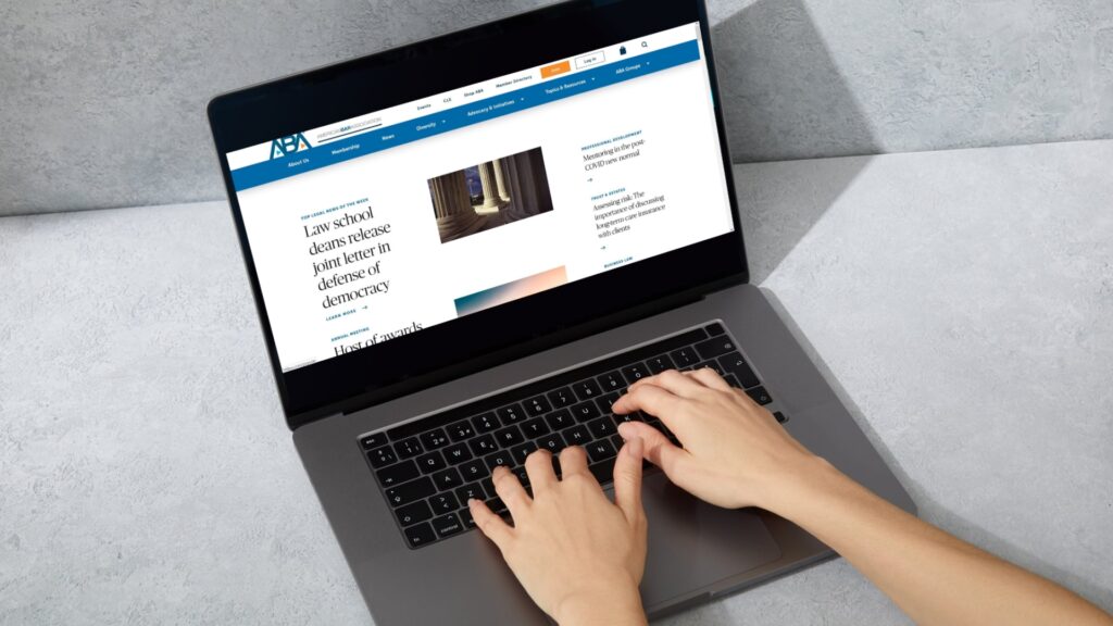 person navigating free legal aid website on a laptop computer